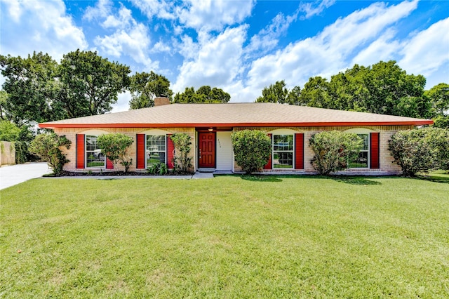 4430 Peridot Ln, Friendswood, TX 77546 - ranch-style home with a front lawn, a chimney, and brick siding