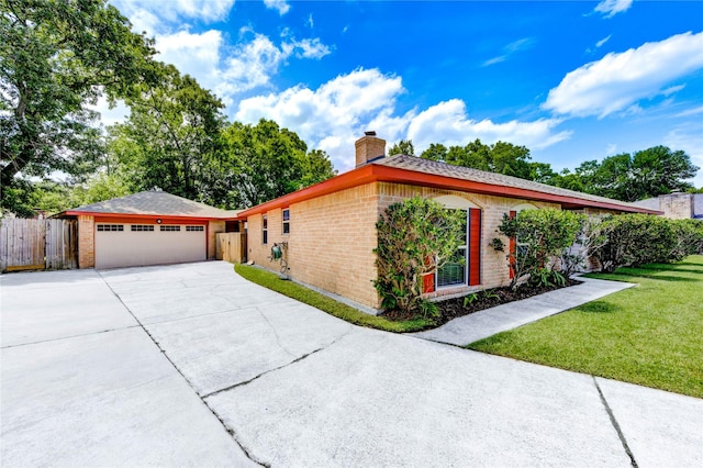 4430 Peridot Ln, Friendswood, TX 77546 - view of side of home featuring brick siding, a chimney, driveway, and a garage