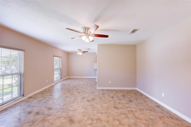 4430 Peridot Ln, Friendswood, TX 77546 - empty room with a ceiling fan, a textured ceiling, light tile patterned flooring, and baseboards