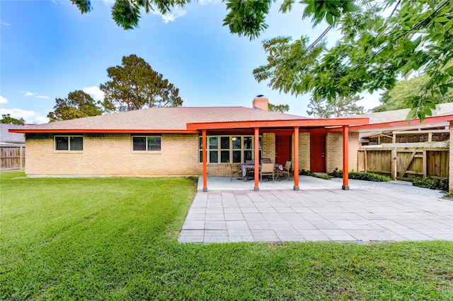4430 Peridot Ln, Friendswood, TX 77546 - rear view of house featuring brick siding, a chimney, and a patio area