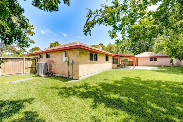 4430 Peridot Ln, Friendswood, TX 77546 - back of house with central air condition unit, a patio, brick siding, and a chimney
