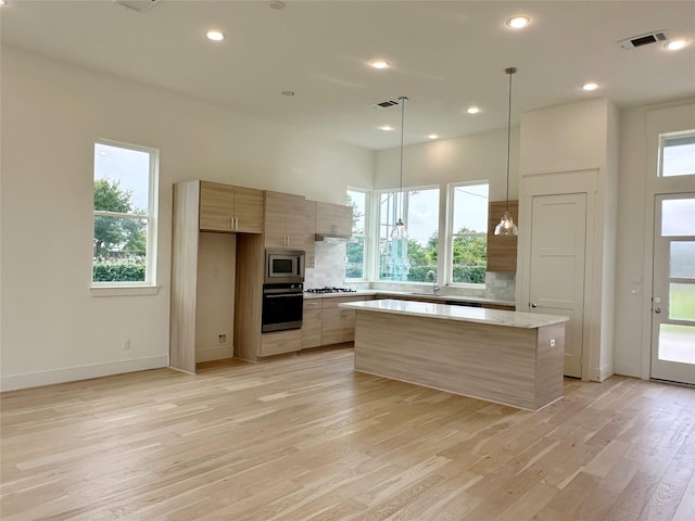 2806 Rosefield Dr, Houston, TX 77080 - kitchen with wall oven, stainless steel microwave, modern cabinets, a sink, and light wood-style floors