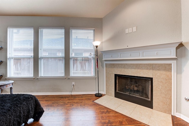 21127 Gladys Yoakum Dr, Richmond, TX 77406 - bedroom with wood finished floors, a tile fireplace, and baseboards