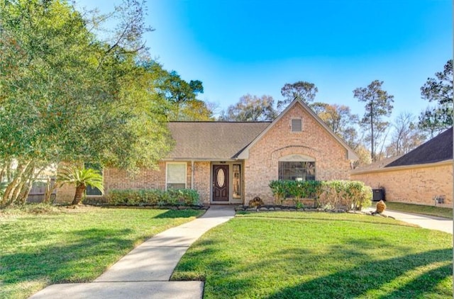 3838 Fawn Creek Dr, Houston, TX 77339 - view of front facade featuring a front yard and brick siding