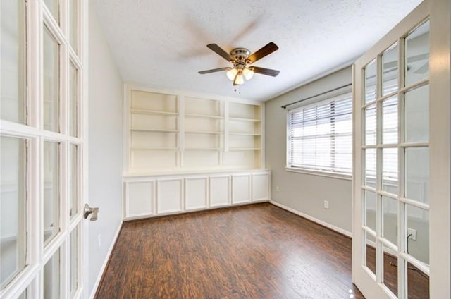 3838 Fawn Creek Dr, Houston, TX 77339 - unfurnished room with dark wood-style floors, ceiling fan, a textured ceiling, baseboards, and french doors