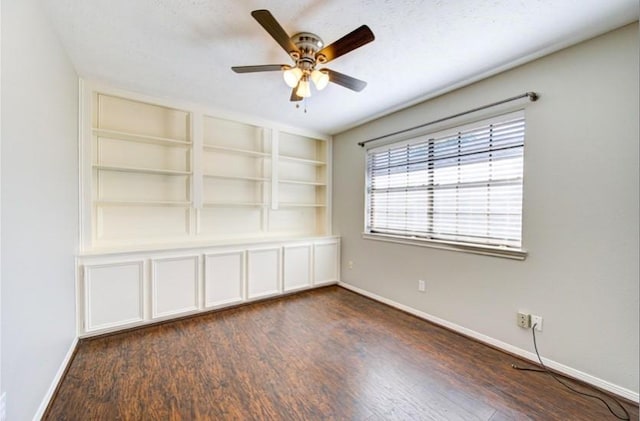 3838 Fawn Creek Dr, Houston, TX 77339 - unfurnished room featuring dark wood finished floors, ceiling fan, baseboards, and built in features