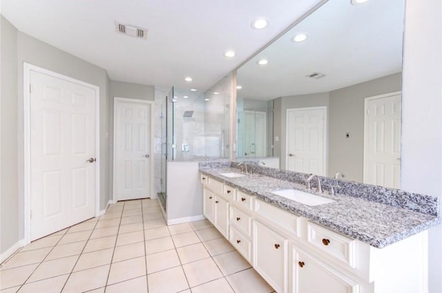 3838 Fawn Creek Dr, Houston, TX 77339 - full bath featuring double vanity, a stall shower, recessed lighting, tile patterned flooring, and baseboards