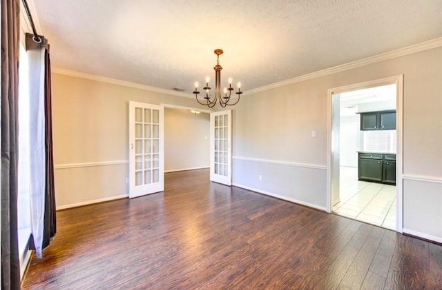 3838 Fawn Creek Dr, Houston, TX 77339 - unfurnished room with french doors, wood finished floors, a chandelier, crown molding, and baseboards