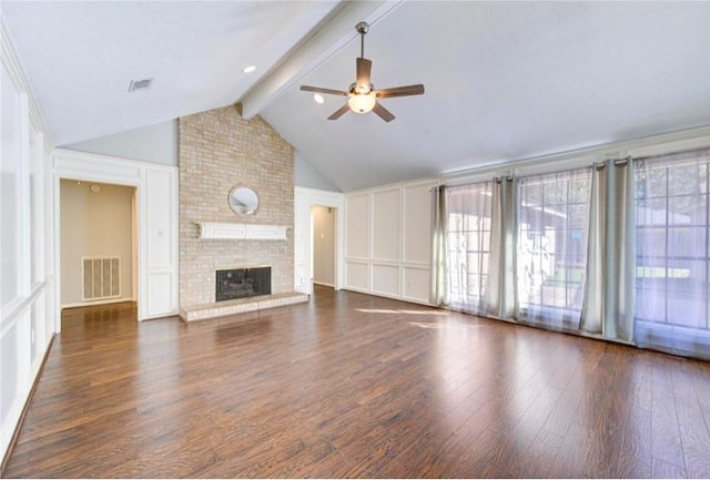 3838 Fawn Creek Dr, Houston, TX 77339 - unfurnished living room featuring a ceiling fan, a decorative wall, wood finished floors, and a fireplace