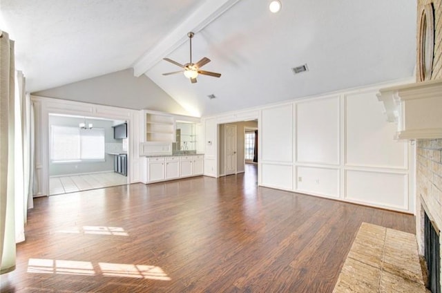 3838 Fawn Creek Dr, Houston, TX 77339 - unfurnished living room featuring a fireplace, a decorative wall, ceiling fan, wood finished floors, and built in features