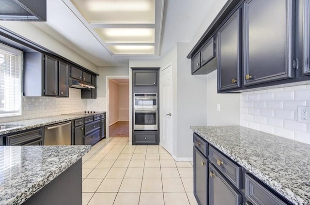 3838 Fawn Creek Dr, Houston, TX 77339 - kitchen featuring appliances with stainless steel finishes, backsplash, light tile patterned floors, and light stone counters