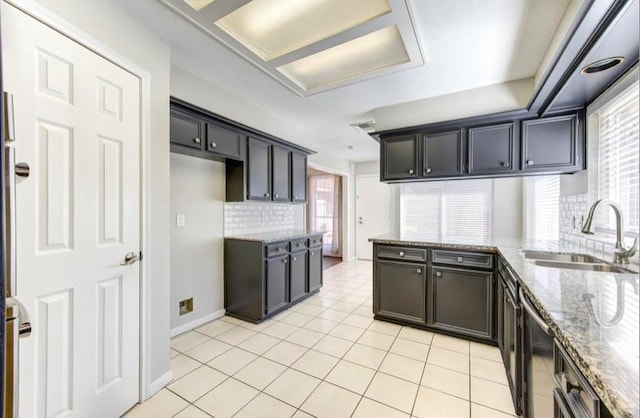 3838 Fawn Creek Dr, Houston, TX 77339 - kitchen with a sink, backsplash, light stone counters, and light tile patterned floors