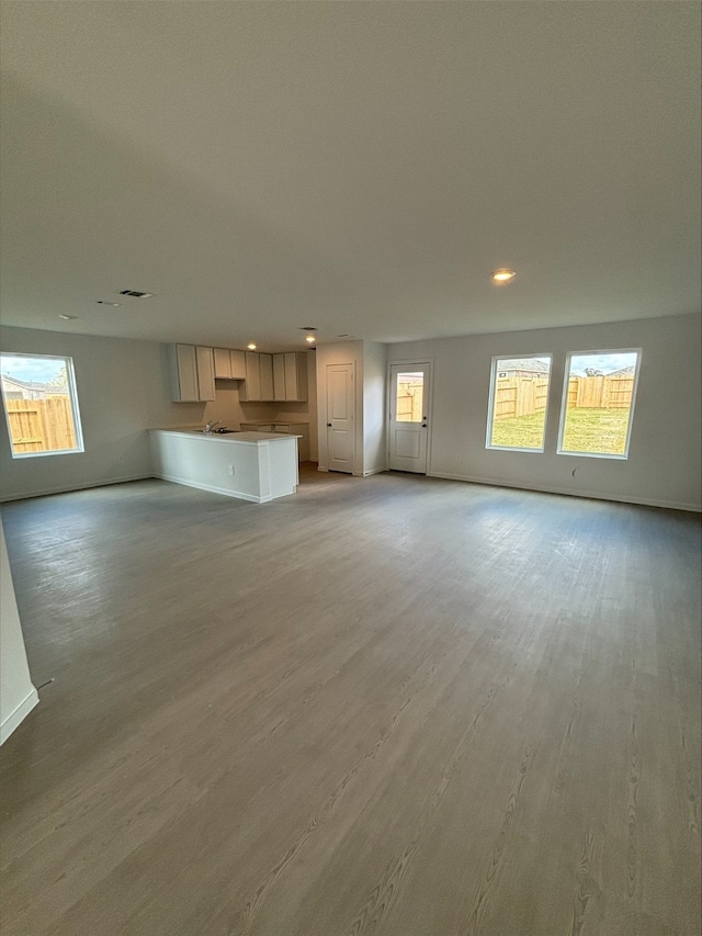 3054 Mallorca Dr, Conroe, TX 77301 - unfurnished living room featuring light wood-style floors and baseboards