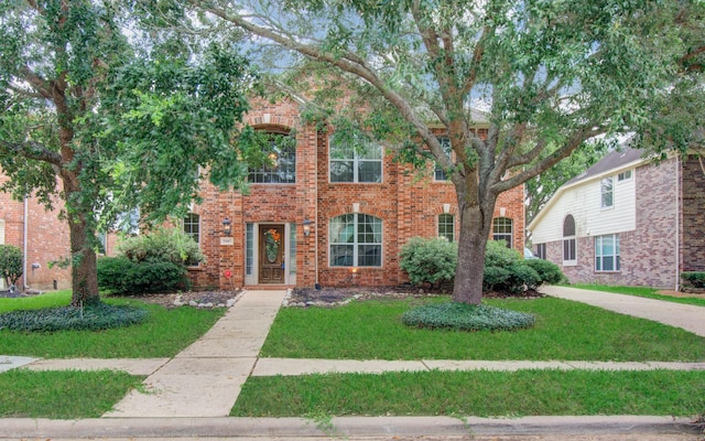 2107 Blue Water Bay Dr, Katy, TX 77494 - traditional-style home featuring a front lawn and brick siding