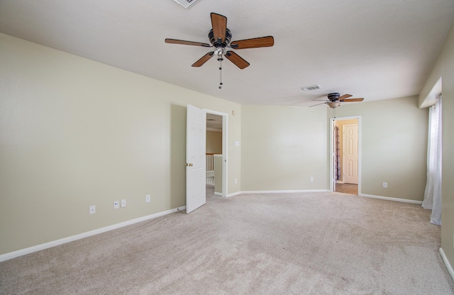 2107 Blue Water Bay Dr, Katy, TX 77494 - empty room featuring a ceiling fan, light colored carpet, and baseboards