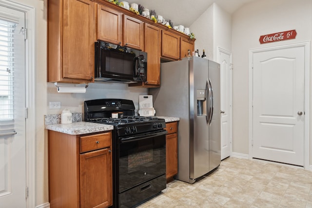 16718 Highland Villa Ln, Humble, TX 77396 - kitchen featuring black appliances, brown cabinets, and baseboards