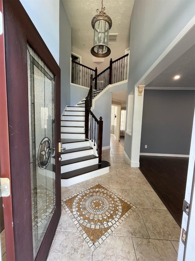 7802 Strathclyde Sound Rd, Houston, TX 77095 - entryway featuring a chandelier, baseboards, stairs, a high ceiling, and ornamental molding