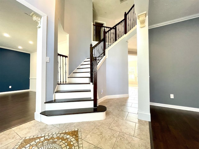 7802 Strathclyde Sound Rd, Houston, TX 77095 - staircase with baseboards, crown molding, tile patterned floors, a towering ceiling, and recessed lighting