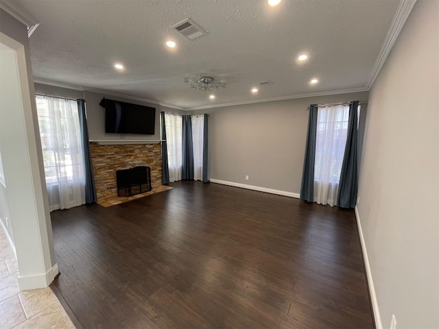 7802 Strathclyde Sound Rd, Houston, TX 77095 - unfurnished living room with healthy amount of natural light, baseboards, a stone fireplace, crown molding, and dark wood-type flooring