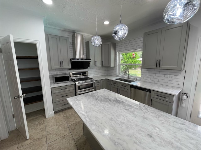 7802 Strathclyde Sound Rd, Houston, TX 77095 - kitchen with gray cabinetry, stainless steel appliances, a sink, wall chimney range hood, and decorative backsplash