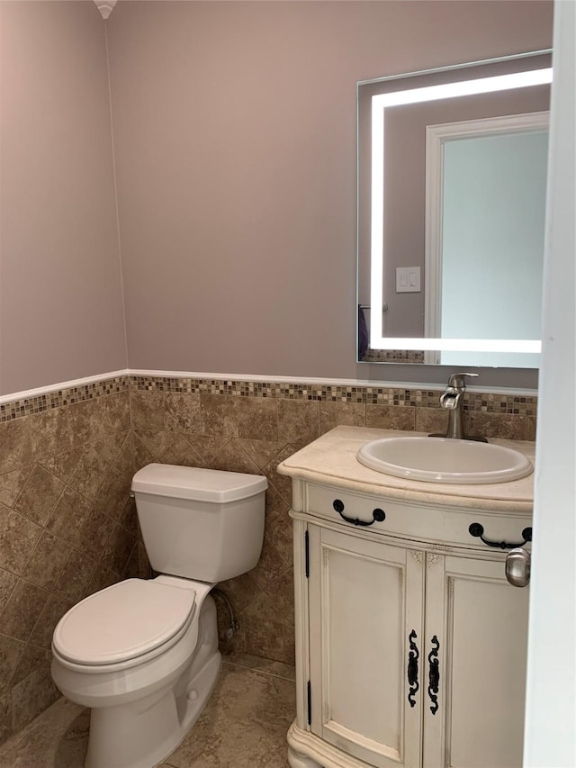 7802 Strathclyde Sound Rd, Houston, TX 77095 - bathroom featuring tile walls, vanity, toilet, and wainscoting