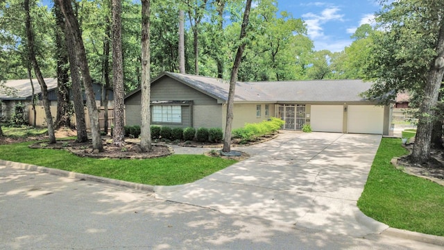 24 Woody Creek Dr, Conroe, TX 77301 - view of front of home with an attached garage, driveway, a front lawn, and brick siding