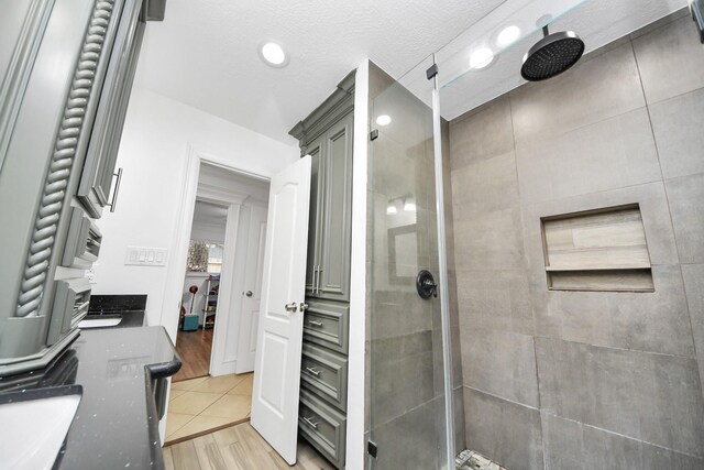 24 Woody Creek Dr, Conroe, TX 77301 - bathroom with a stall shower and wood finished floors