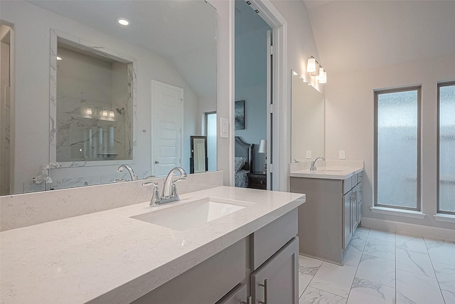 29042 Hauter Way, Fulshear, TX 77441 - ensuite bathroom featuring marble look tile flooring, two vanities, a walk in shower, recessed lighting, and vaulted ceiling