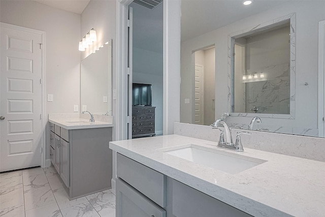 29042 Hauter Way, Fulshear, TX 77441 - bathroom with two vanities, marble look tile flooring, and recessed lighting