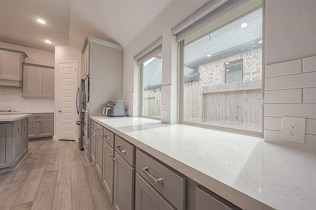 29042 Hauter Way, Fulshear, TX 77441 - kitchen featuring gray cabinetry, decorative backsplash, light wood finished floors, light countertops, and recessed lighting