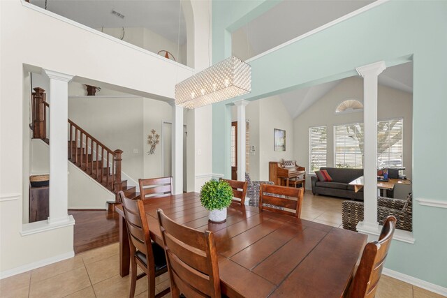 44 Parkway Pl, Houston, TX 77040 - dining area with ornate columns, light tile patterned floors, baseboards, and high vaulted ceiling
