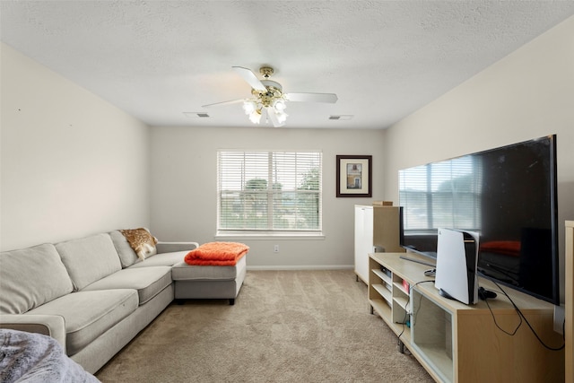 44 Parkway Pl, Houston, TX 77040 - living room with light colored carpet, ceiling fan, baseboards, and a textured ceiling