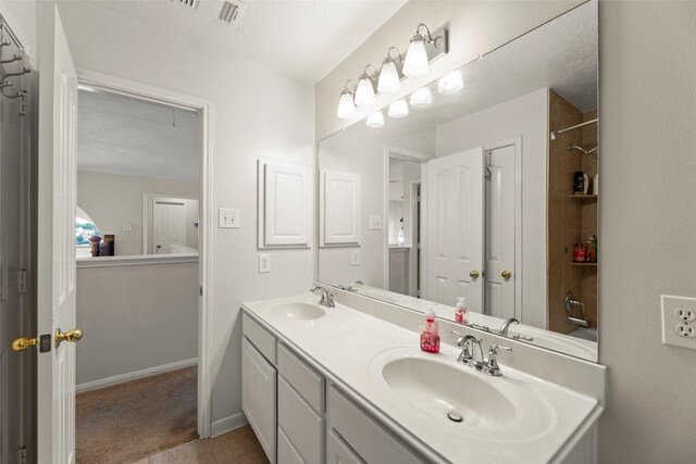 44 Parkway Pl, Houston, TX 77040 - full bathroom featuring double vanity, tile patterned flooring, and baseboards