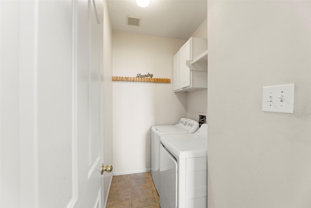 44 Parkway Pl, Houston, TX 77040 - washroom with washer and dryer, cabinet space, baseboards, and light tile patterned flooring