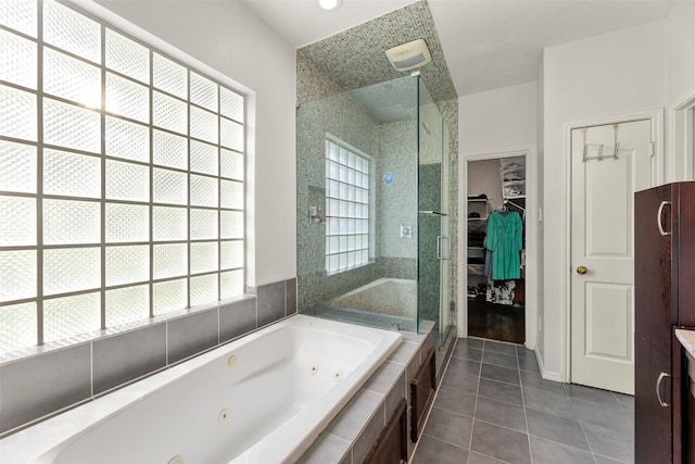 44 Parkway Pl, Houston, TX 77040 - full bath with tile patterned flooring, a shower stall, a jetted tub, and a spacious closet