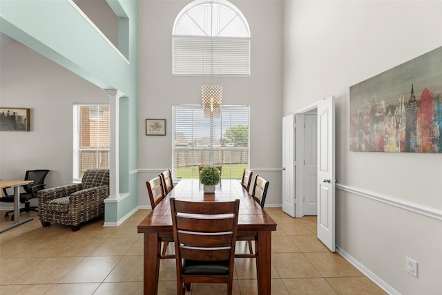 44 Parkway Pl, Houston, TX 77040 - dining space with a towering ceiling, light tile patterned floors, ornate columns, and baseboards