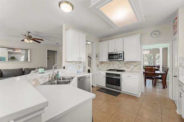 44 Parkway Pl, Houston, TX 77040 - kitchen with stainless steel appliances, a sink, tasteful backsplash, ceiling fan, and white cabinets