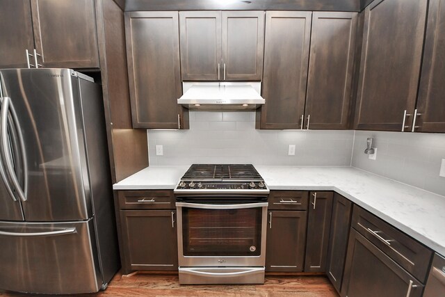 310 Eado Park Cir, Houston, TX 77020 - kitchen featuring appliances with stainless steel finishes, under cabinet range hood, light wood-style floors, and dark brown cabinets