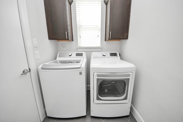 310 Eado Park Cir, Houston, TX 77020 - laundry area featuring cabinet space, washing machine and dryer, and tile patterned flooring