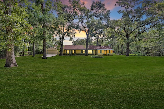 5614 Whipporwill Rd, Conroe, TX 77303 - yard at dusk with a detached garage and a yard