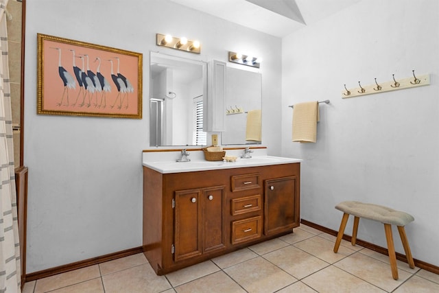 5614 Whipporwill Rd, Conroe, TX 77303 - full bath with double vanity, a shower, tile patterned flooring, and baseboards