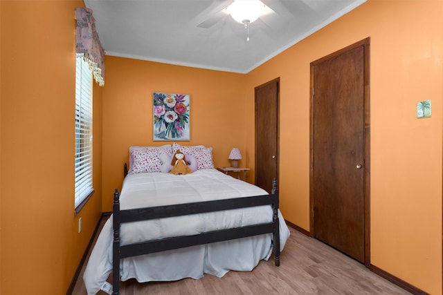 5614 Whipporwill Rd, Conroe, TX 77303 - bedroom featuring ornamental molding, light wood finished floors, ceiling fan, and multiple windows