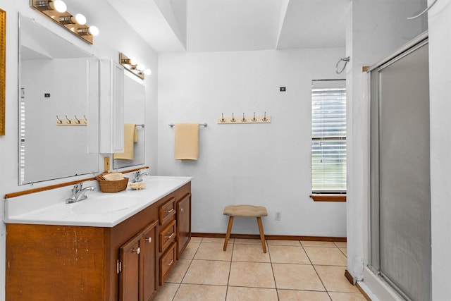 5614 Whipporwill Rd, Conroe, TX 77303 - full bathroom featuring double vanity, a stall shower, tile patterned floors, and baseboards