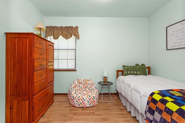 5614 Whipporwill Rd, Conroe, TX 77303 - bedroom with light wood finished floors and baseboards