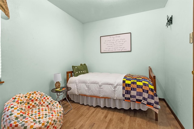 5614 Whipporwill Rd, Conroe, TX 77303 - bedroom with wood finished floors and baseboards