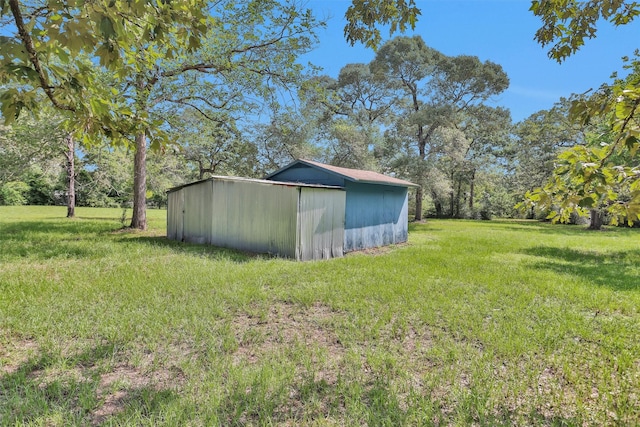 5614 Whipporwill Rd, Conroe, TX 77303 - view of grassy yard featuring an outbuilding and a pole building