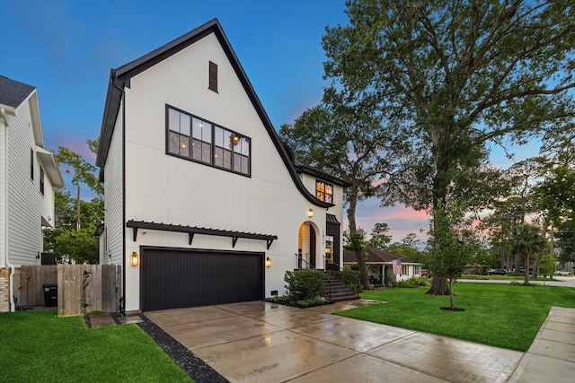 1917 Ebony Ln, Houston, TX 77018 - view of front of house with an attached garage, concrete driveway, and stucco siding