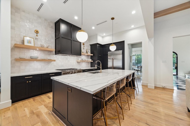 1917 Ebony Ln, Houston, TX 77018 - kitchen featuring open shelves, stainless steel built in fridge, dark cabinetry, light wood-type flooring, and recessed lighting