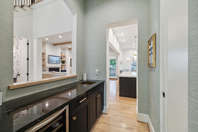 1917 Ebony Ln, Houston, TX 77018 - bar area with light wood-type flooring, a high ceiling, a fireplace, and recessed lighting