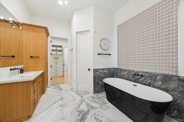 1917 Ebony Ln, Houston, TX 77018 - bathroom featuring marble finish flooring, vanity, a freestanding tub, and tile walls